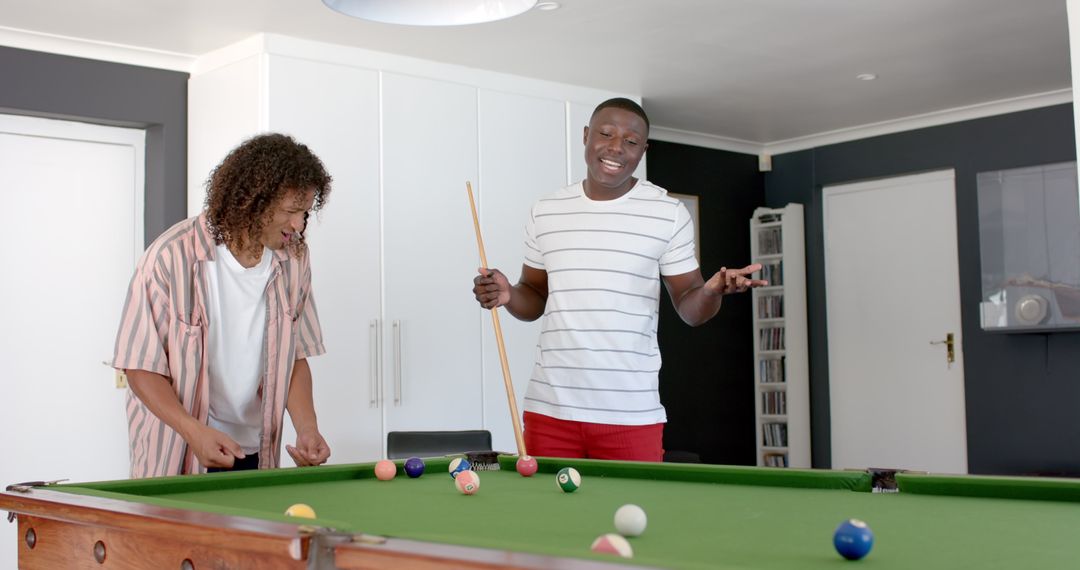 Friends Enjoying Leisurely Game of Pool at Home