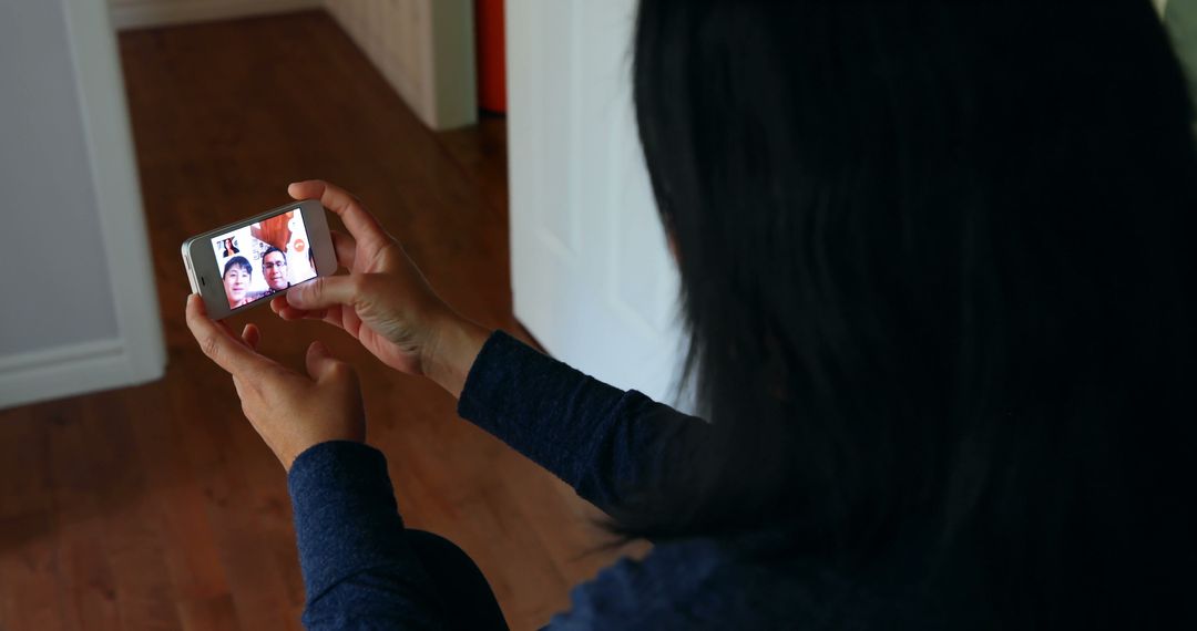 Woman video calling on smartphone at home - Free Images, Stock Photos and Pictures on Pikwizard.com