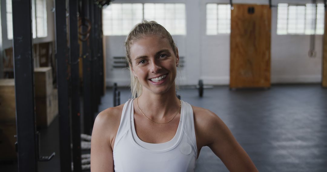 Smiling Woman in Fitness Clothing in Gym - Free Images, Stock Photos and Pictures on Pikwizard.com