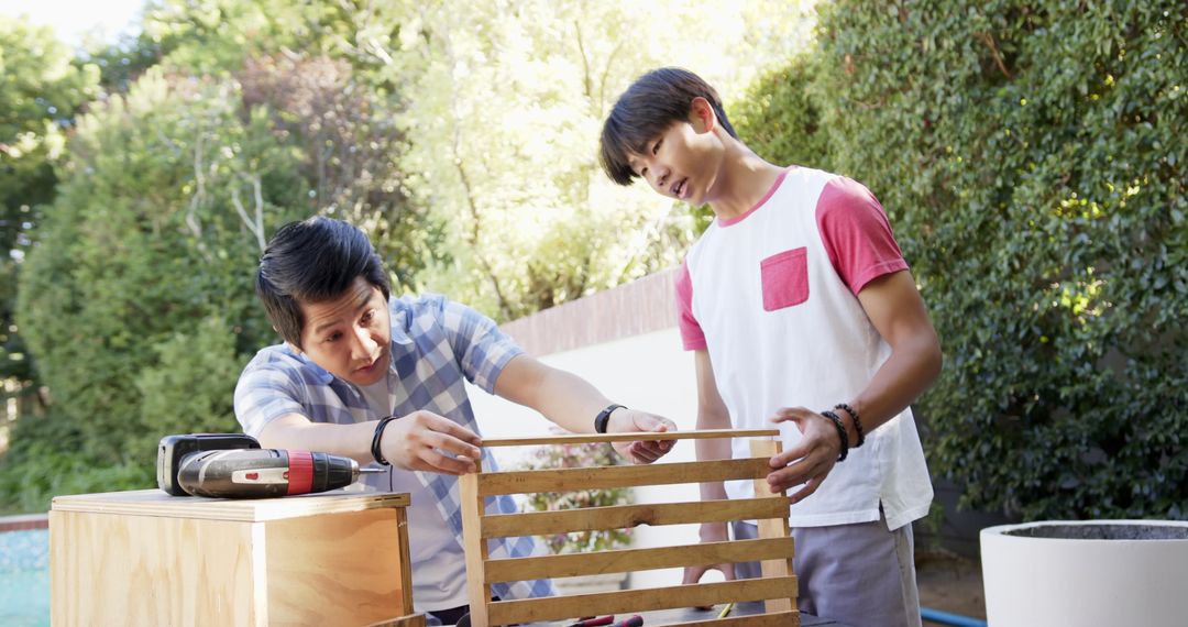 Father and Son Collaborating on Backyard Woodworking Project