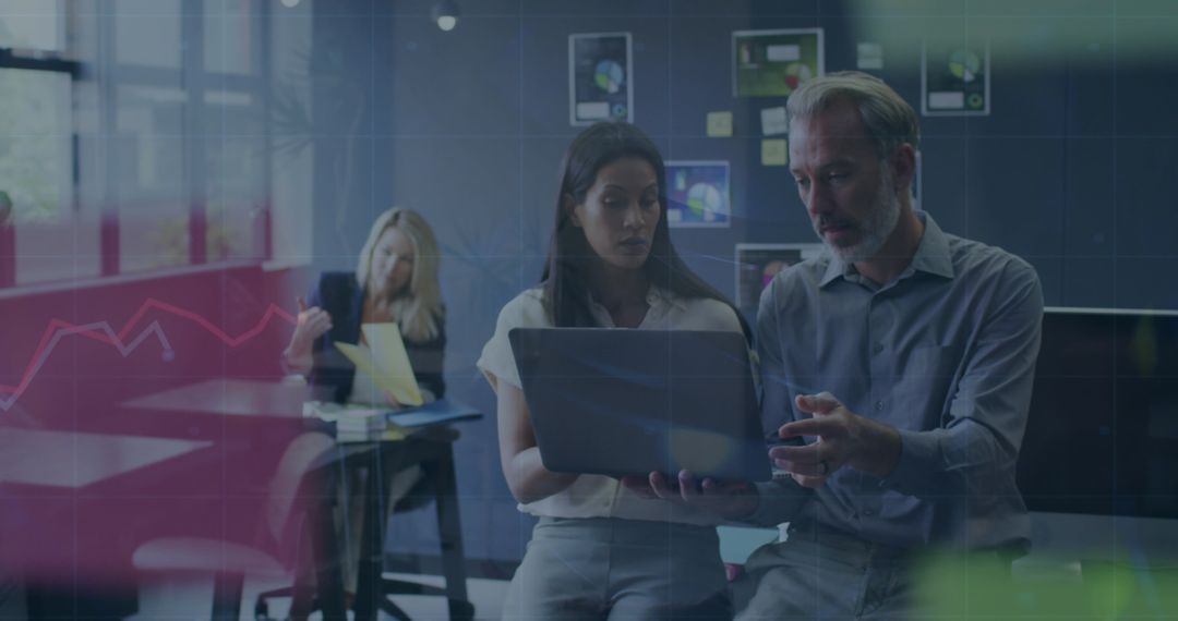 Diverse Business Team Collaborating on Laptop in Modern Office