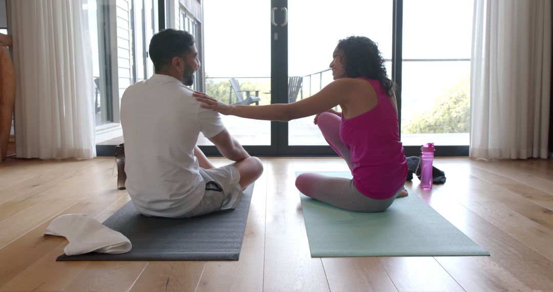 Couple Relaxing and Connecting on Yoga Mats at Home