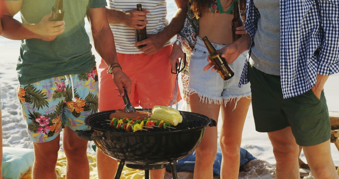 Friends Enjoying Beach Barbecue with Grilled Veggies - Free Images, Stock Photos and Pictures on Pikwizard.com