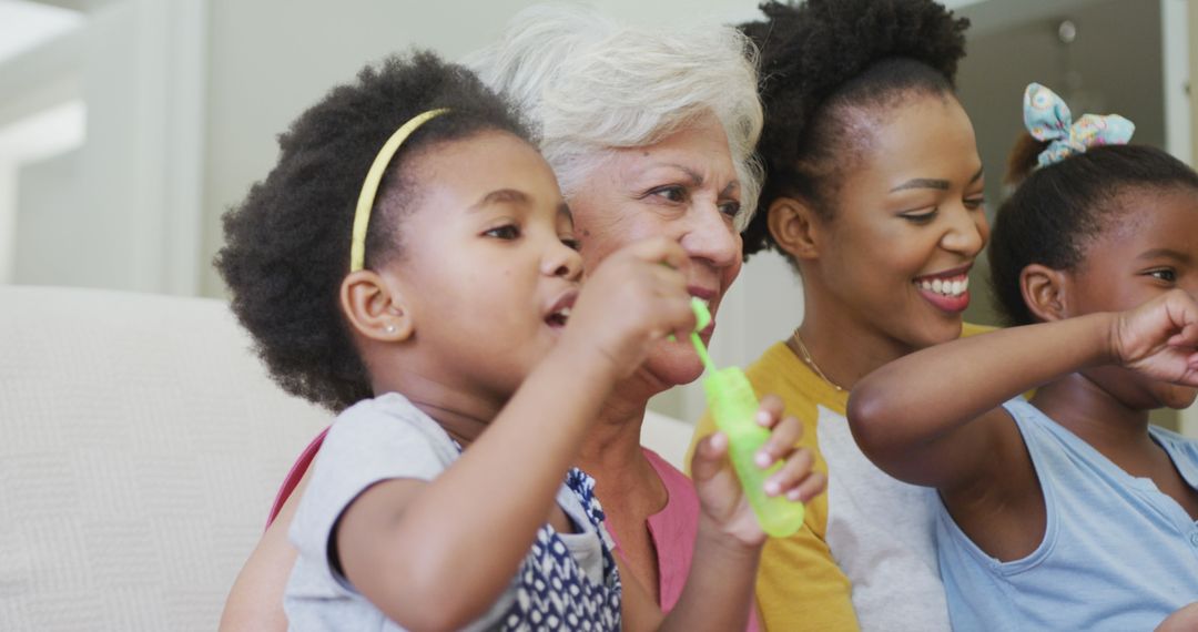 Generations Enjoying Fun Time Blowing Bubbles Together Indoors