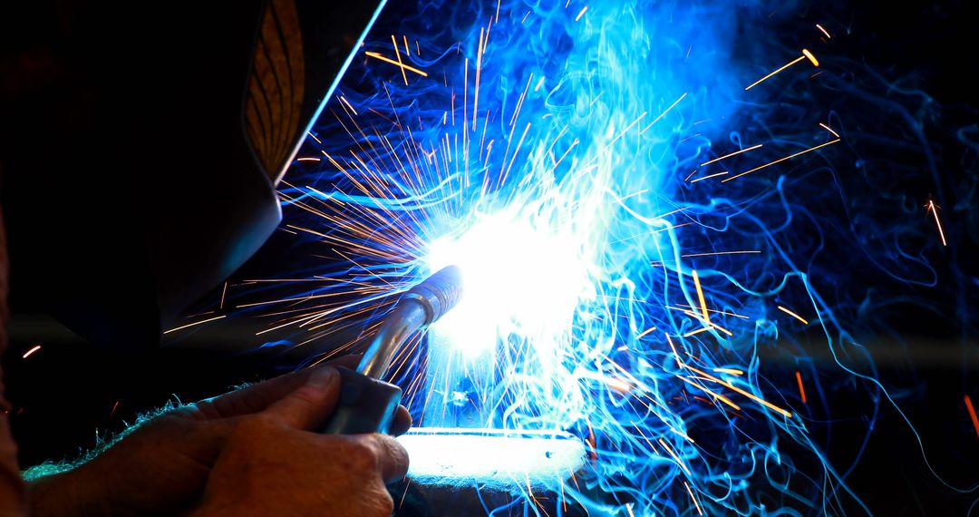 Welder with torch creating bright sparks in workshop - Free Images, Stock Photos and Pictures on Pikwizard.com