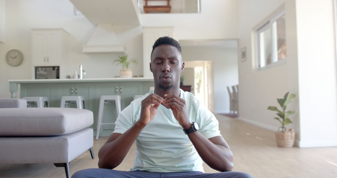 Man Meditating in Modern Living Room for Mental Wellness - Free Images, Stock Photos and Pictures on Pikwizard.com