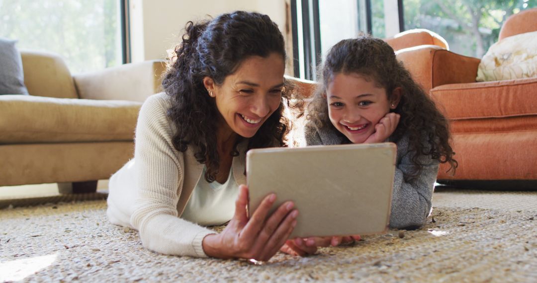 Mother and Daughter Lying on Floor Watching Tablet Together - Free Images, Stock Photos and Pictures on Pikwizard.com