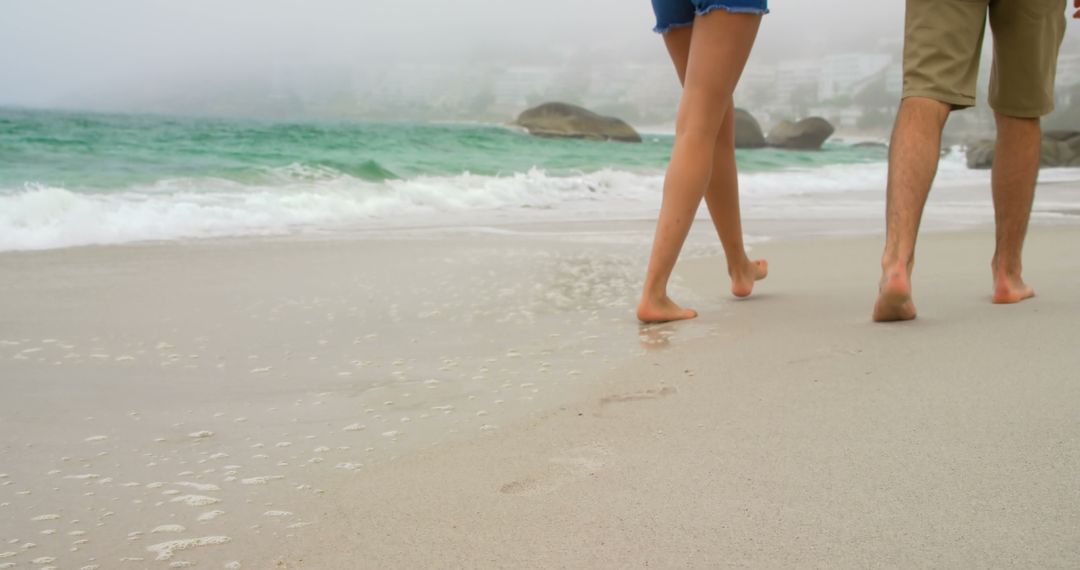 Close-Up of Couple Strolling Along Serene Beach Destination