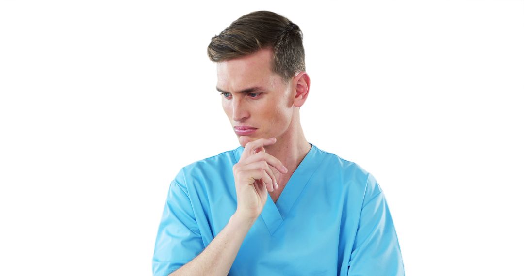 Pensive Male Medical Professional in Blue Scrubs - Free Images, Stock Photos and Pictures on Pikwizard.com