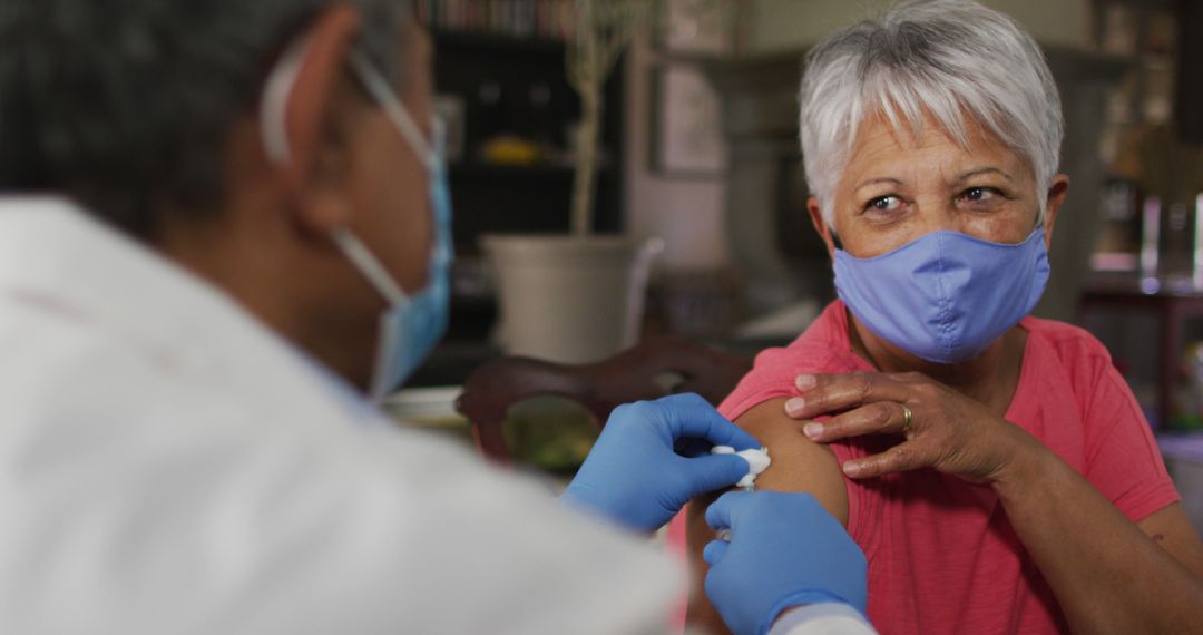 Senior Woman Receiving Vaccination from Medical Professional at Clinic - Free Images, Stock Photos and Pictures on Pikwizard.com