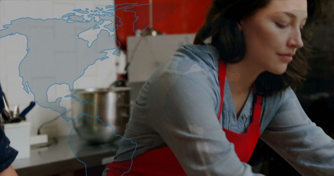 Chef Stirring Dough in Professional Kitchen with Global Map Overlay