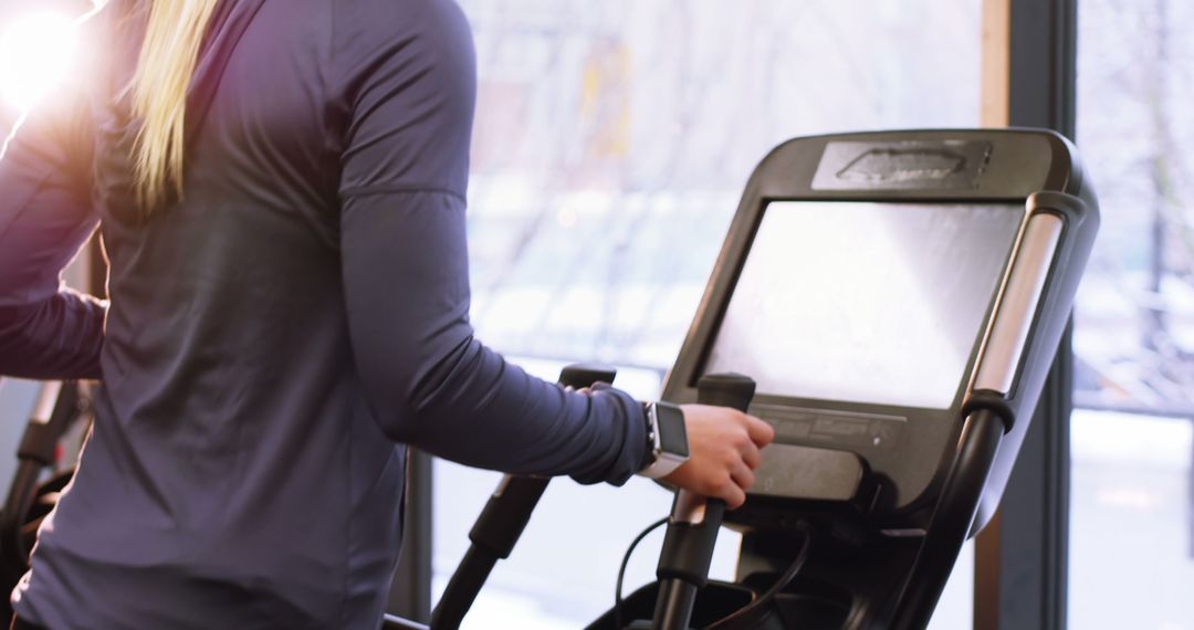 Person Exercising on Elliptical Trainer in Gym - Free Images, Stock Photos and Pictures on Pikwizard.com