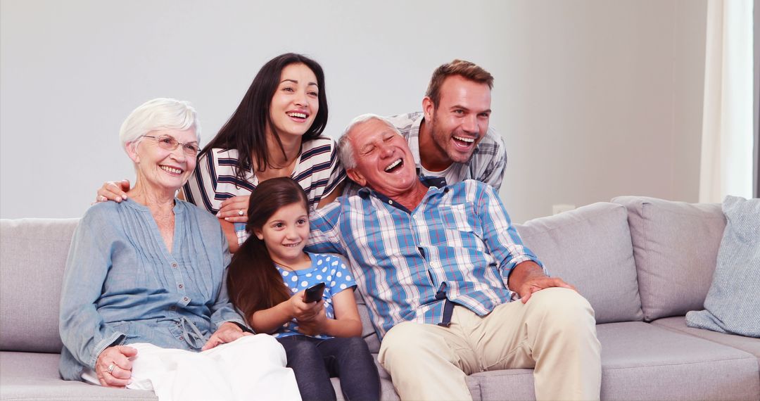 Multi-generational Family Laughing Together on Couch - Free Images, Stock Photos and Pictures on Pikwizard.com