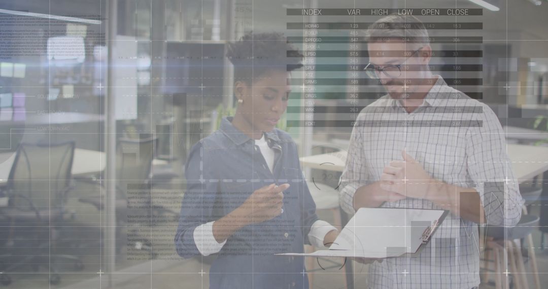 Multicultural Professionals Collaborating on Data Analysis in Modern Office