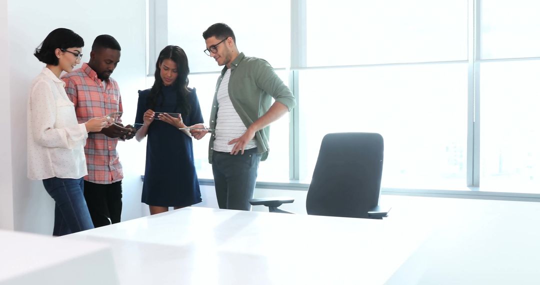 Modern Business Trio Collaborating in Bright Workspace