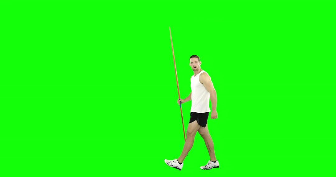 Male Athlete Striding and Holding Javelin on Green Screen Background for Editing