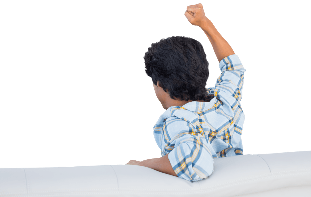 Excited Fan Cheering with Clenched Fist on Couch