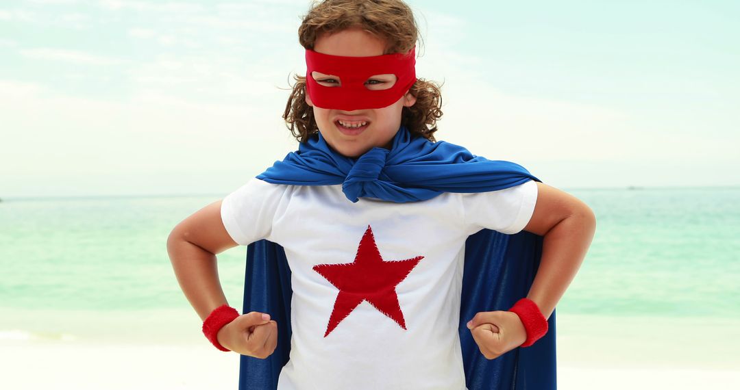 Young Boy Superhero Flexing Muscles on Beach - Free Images, Stock Photos and Pictures on Pikwizard.com