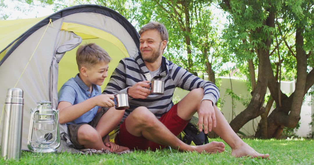 Father and Son Camping Outdoors Enjoying Morning Coffee - Free Images, Stock Photos and Pictures on Pikwizard.com