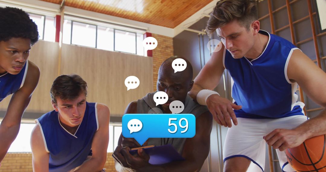 Coach Engaging with Team Using Digital Device in Basketball Practice