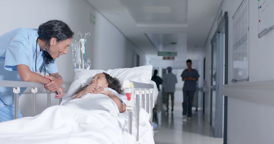 Nurse Comforting Child Patient in Hospital Bed in Bright Corridor - Free Images, Stock Photos and Pictures on Pikwizard.com