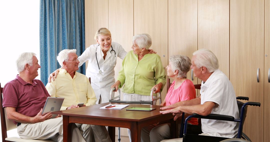 Smiling Nurse Engaging with Happy Seniors in Assisted Living Home - Free Images, Stock Photos and Pictures on Pikwizard.com