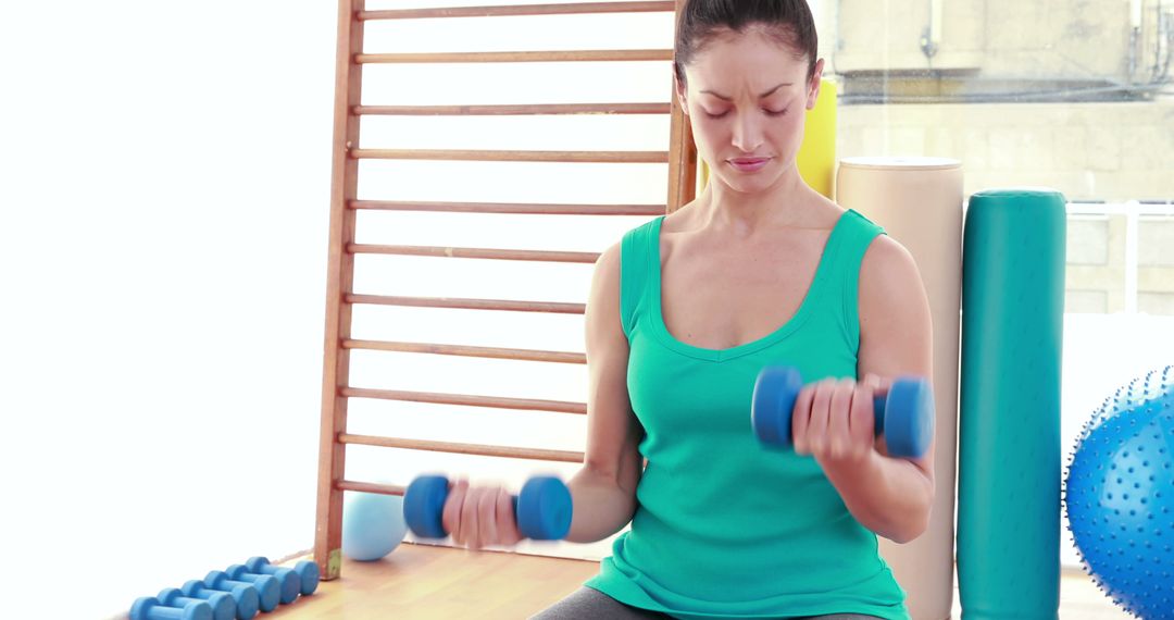 Woman Exercising with Dumbbells in Home Gym - Free Images, Stock Photos and Pictures on Pikwizard.com