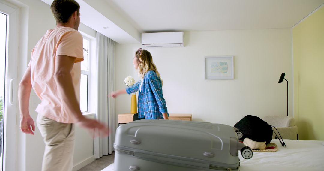 Couple Preparing for Travel with Packing in Modern Bedroom