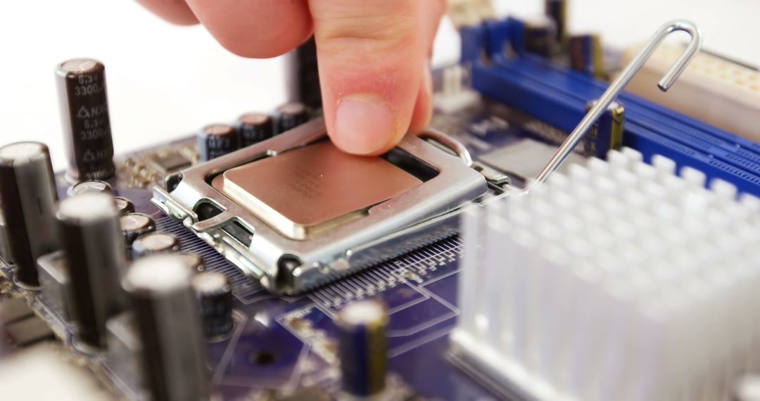 Technician Installing Chip on Motherboard in Workshop