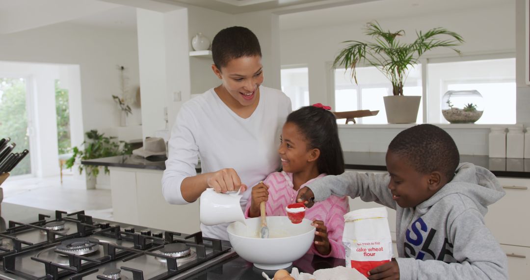 Smiling Mother Baking with Happy Children in Kitchen - Free Images, Stock Photos and Pictures on Pikwizard.com