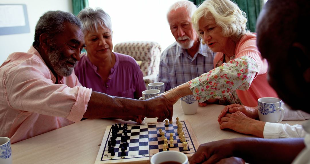Senior Diverse Group Enjoying Leisurely Chess Game at Community Gathering