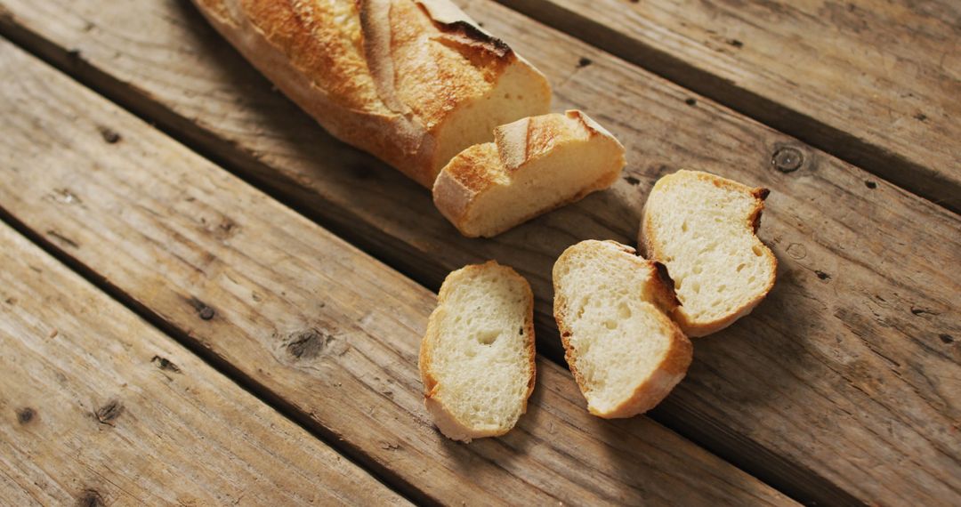 Fresh Baguette Slices on Rustic Wooden Table - Free Images, Stock Photos and Pictures on Pikwizard.com