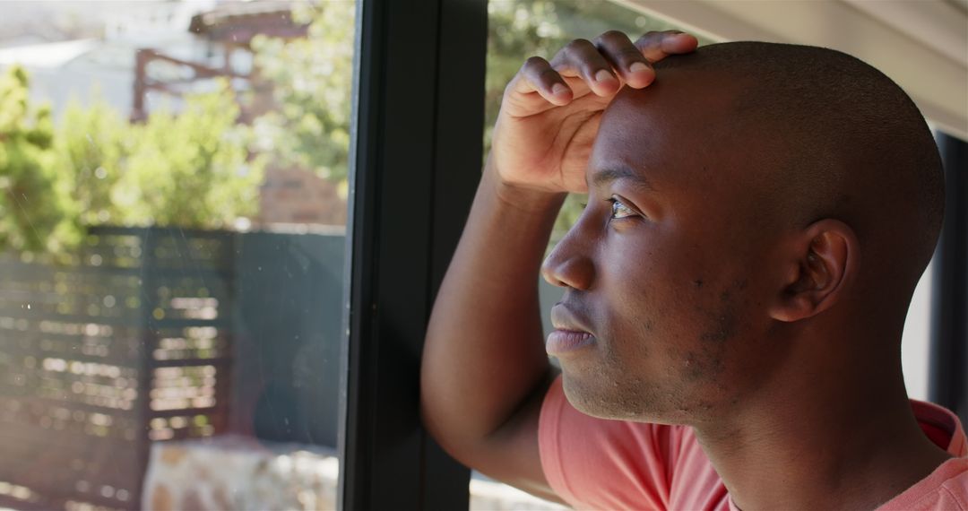 Man Reflective at Window, Enjoying Solitude