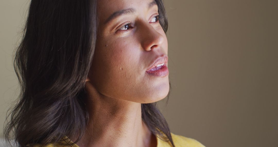 Profile of Serene Woman Enjoying a Calm Moment by Window