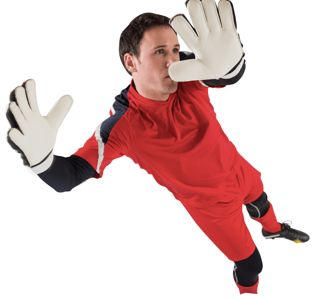 Male Footballer in Red Jumping with Focus on Goalkeeping Skills