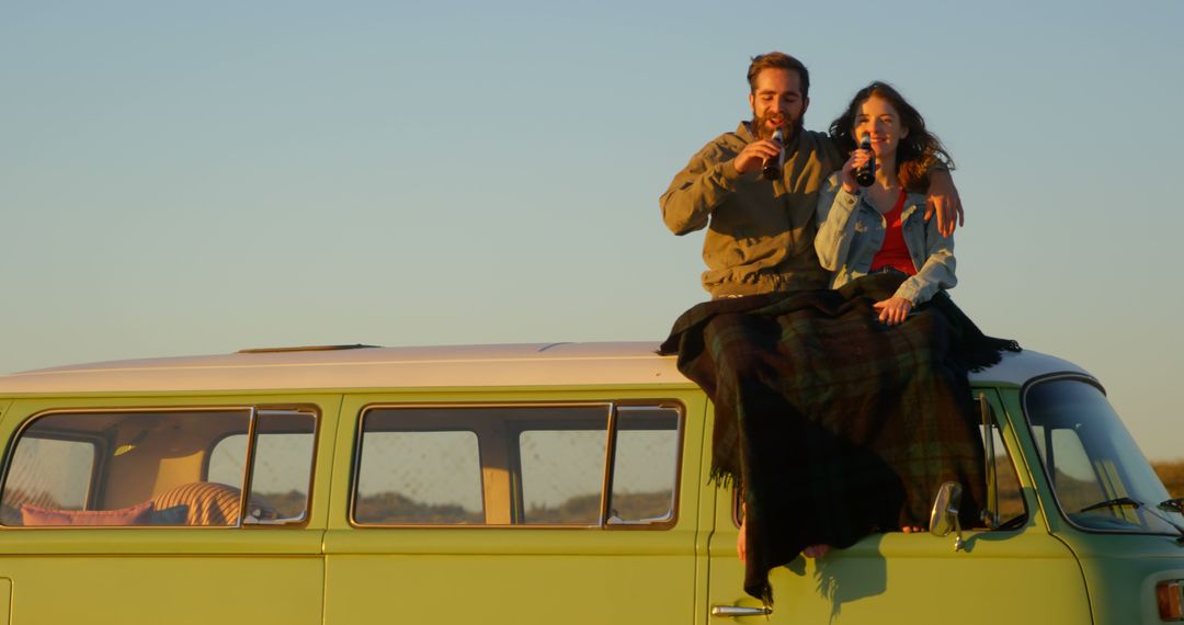 Couple Enjoying Sunset on Vintage Van Roof with Blankets - Free Images, Stock Photos and Pictures on Pikwizard.com