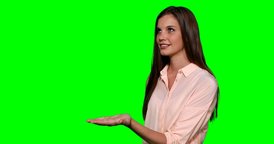 Woman pretending to touch digital screen against green screen - Free Images, Stock Photos and Pictures on Pikwizard.com