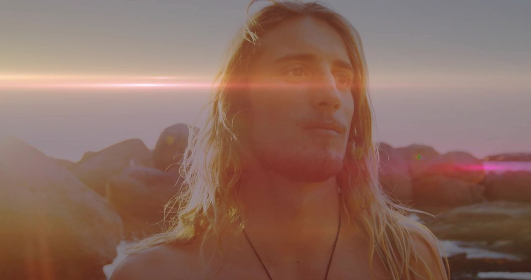 Reflective Blond Man with Lens Flare at Rocky Shore