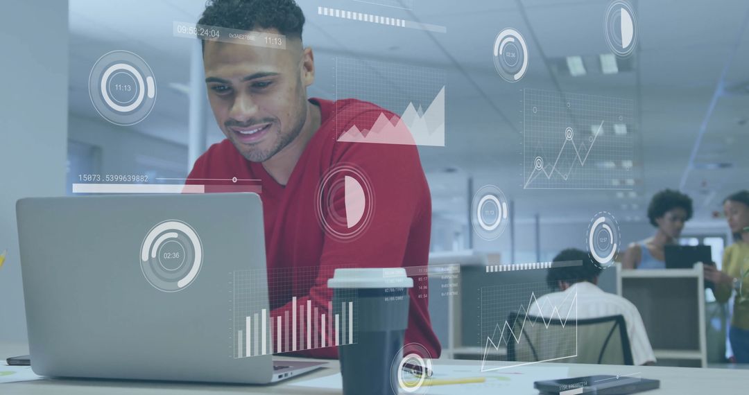 Smiling Man Working with Data Visualization in Modern Open-Plan Office
