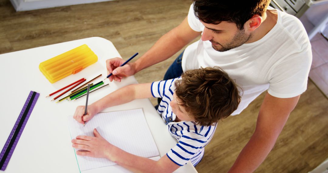 Father and Son Drawing Together at Home - Free Images, Stock Photos and Pictures on Pikwizard.com