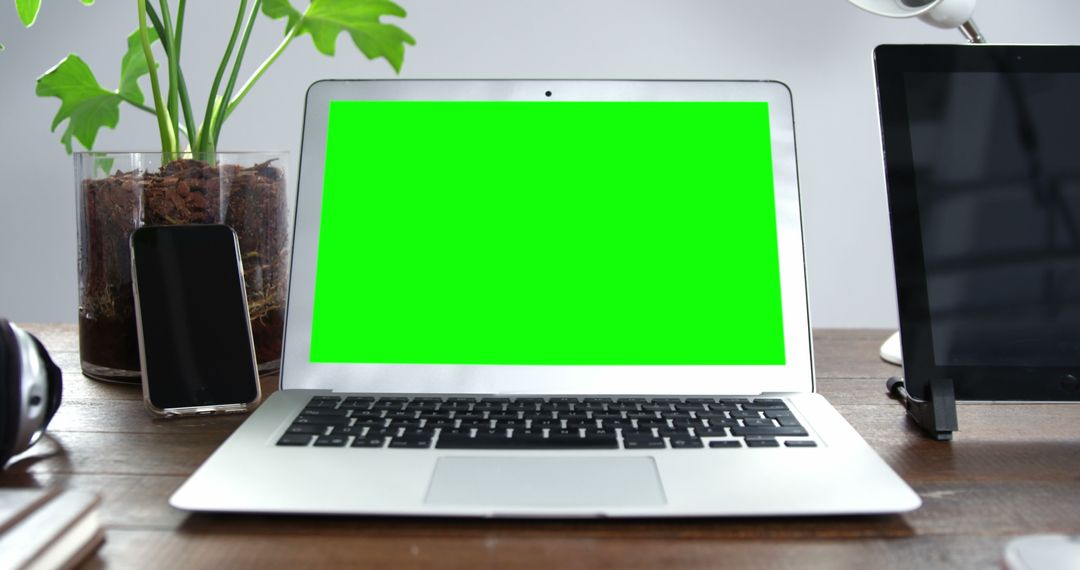 Green Screen Laptop in Modern Workspace with Gadgets - Free Images, Stock Photos and Pictures on Pikwizard.com