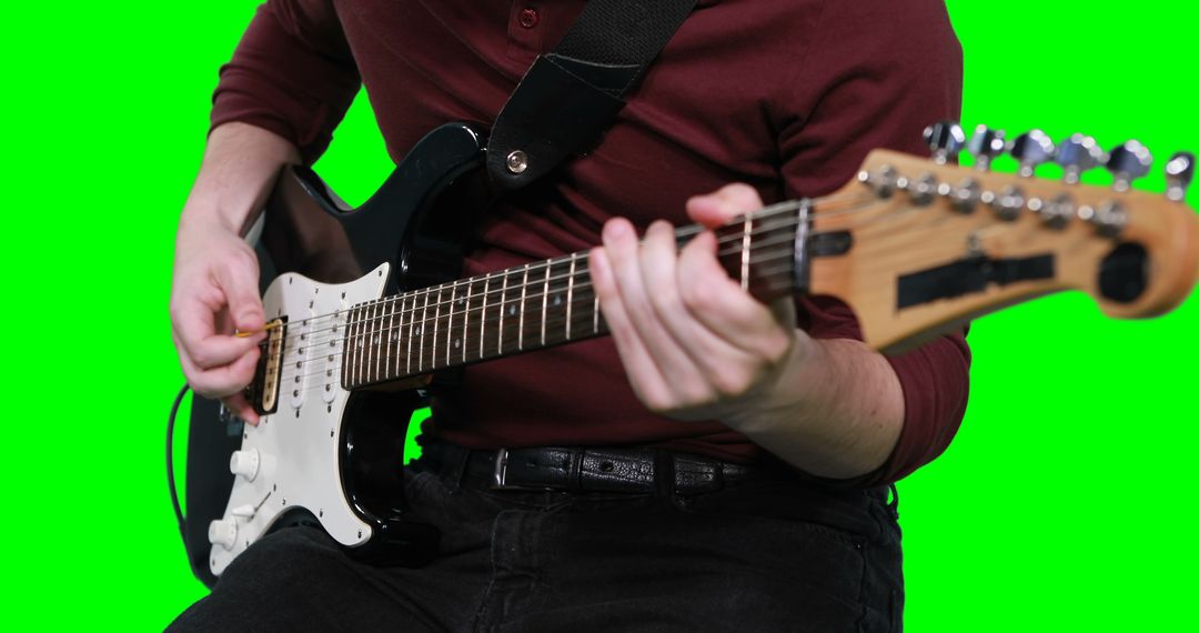 Close-Up of Electric Guitarist Playing Music Against Green Screen - Free Images, Stock Photos and Pictures on Pikwizard.com