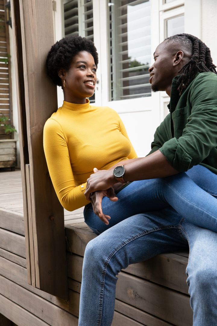 Affectionate Couple Connecting on Rustic Porch with Wristwatch Highlight