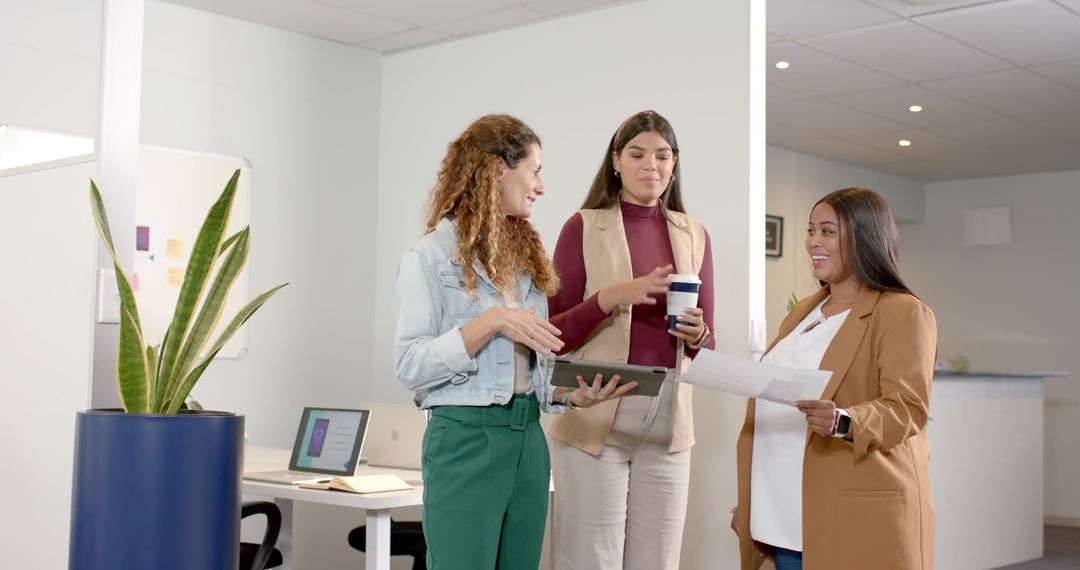 Diverse Businesswomen Discussing Project in Modern Office Environment