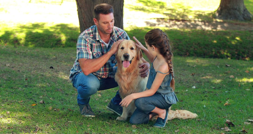 A man and girl enjoy family time with their dog in a sunny park, showcasing joy from pets. - Free Images, Stock Photos and Pictures on Pikwizard.com