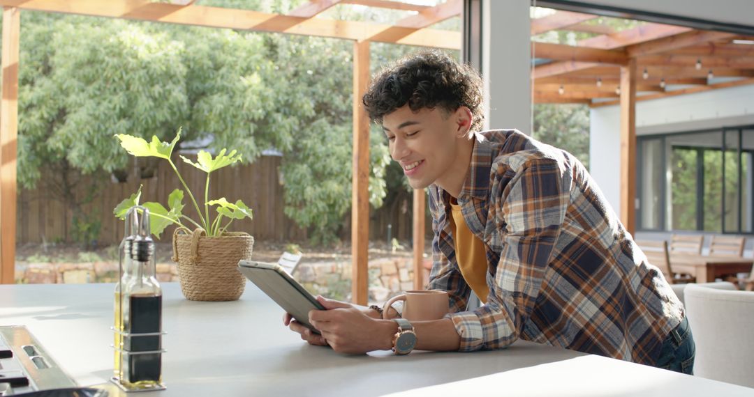 Man Relaxing with Tablet in Modern Home Kitchen