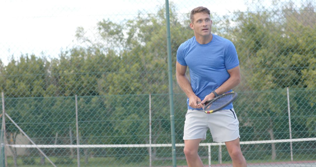 Focused Man Playing Tennis on Outdoor Court - Free Images, Stock Photos and Pictures on Pikwizard.com