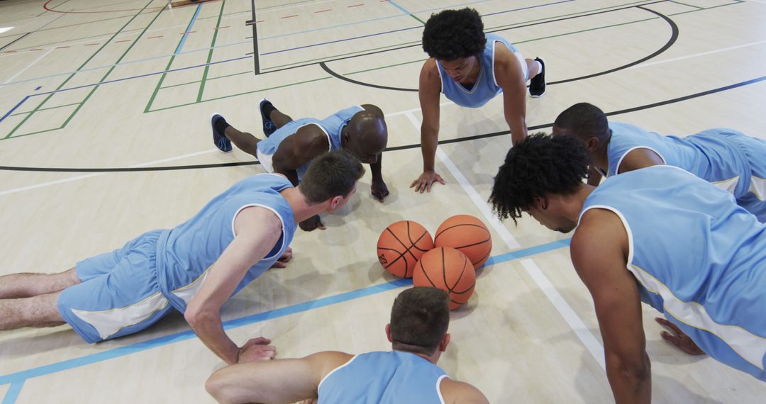 Basketball Team Doing Push-Ups in Gymnasium During Training Session - Free Images, Stock Photos and Pictures on Pikwizard.com