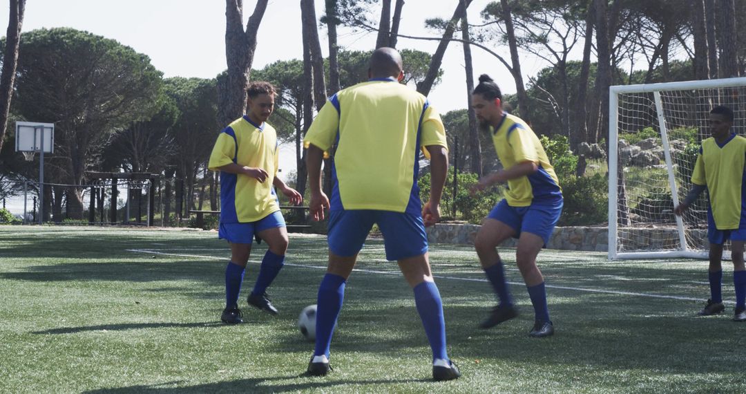 Soccer Players in Yellow Jerseys Practicing Teamwork