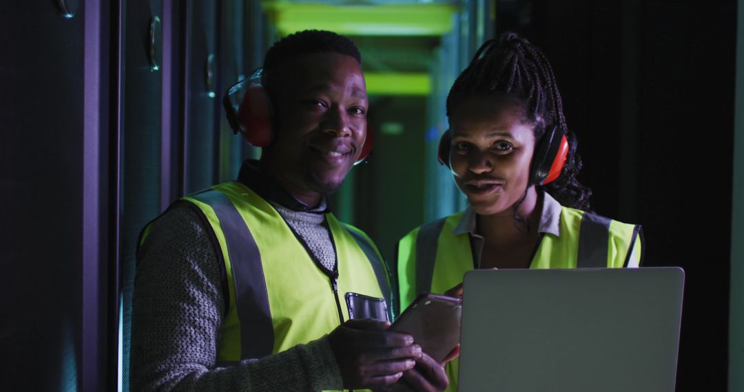 IT Engineers Monitoring Servers with Laptops